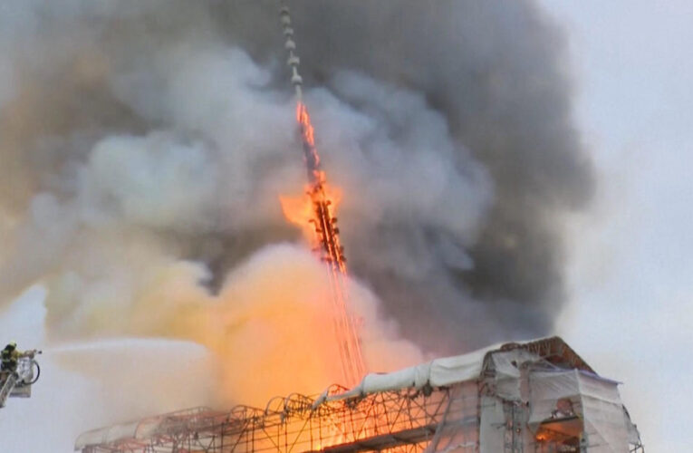 Copenhagen’s historic Old Stock Exchange erupts in flames, collapsing legendary spire