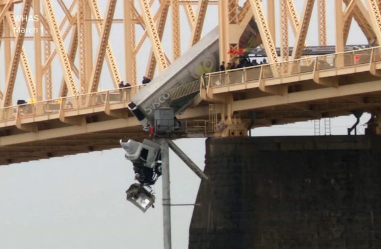 Truck swerves into semi, leaving truck driver dangling from Louisville bridge; video shows rescue