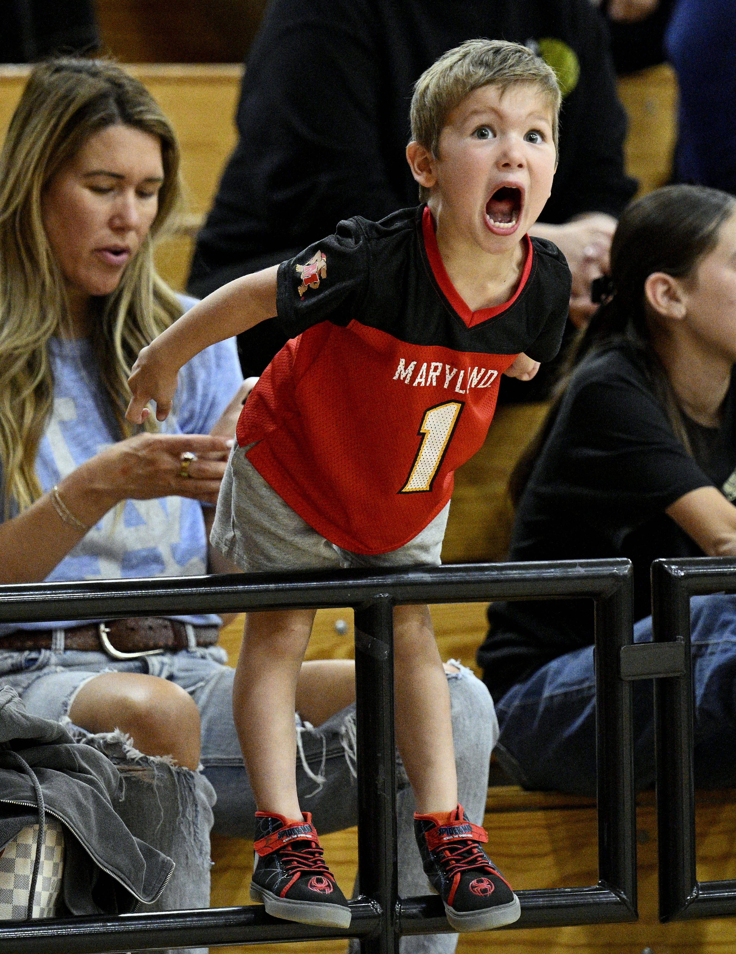 Luke Ford, 4, cheers for the Harlem Wizards during a...