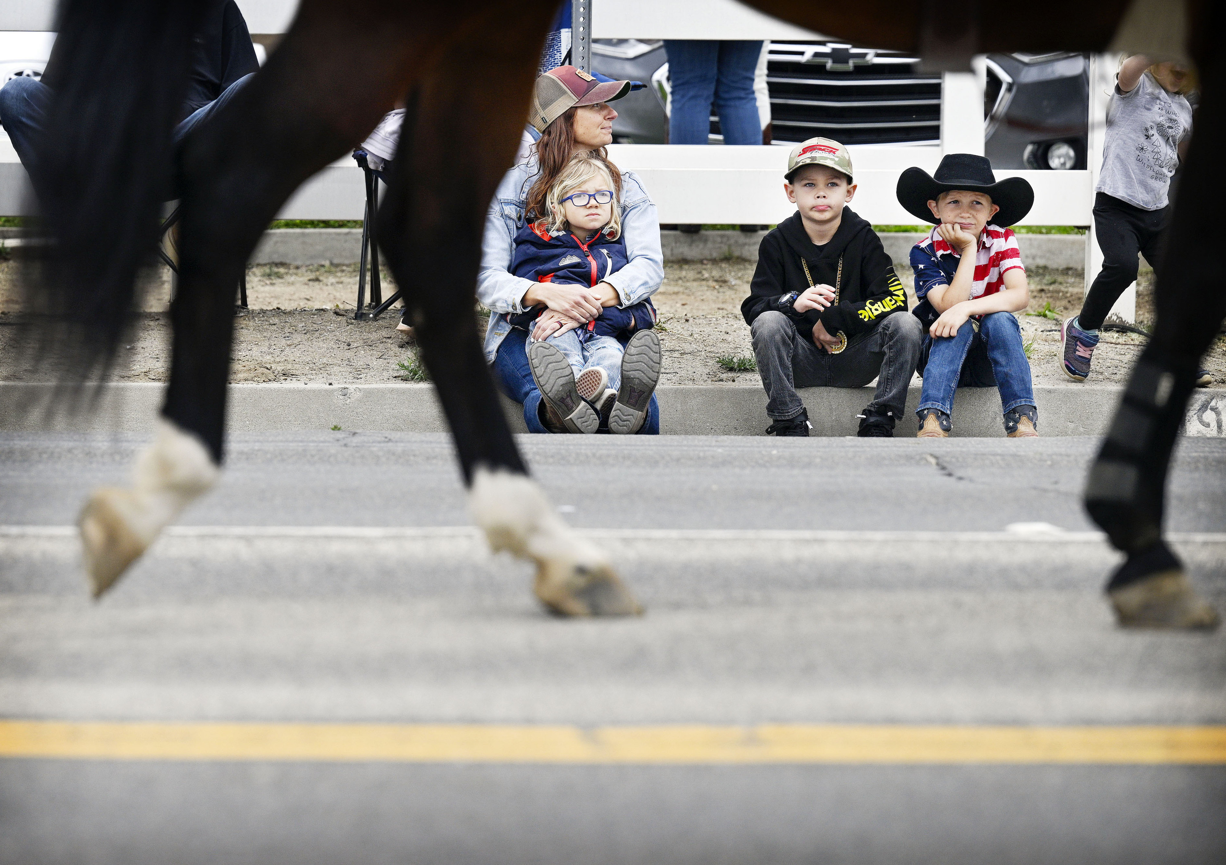 Spectators admire the horses as they march by at the...