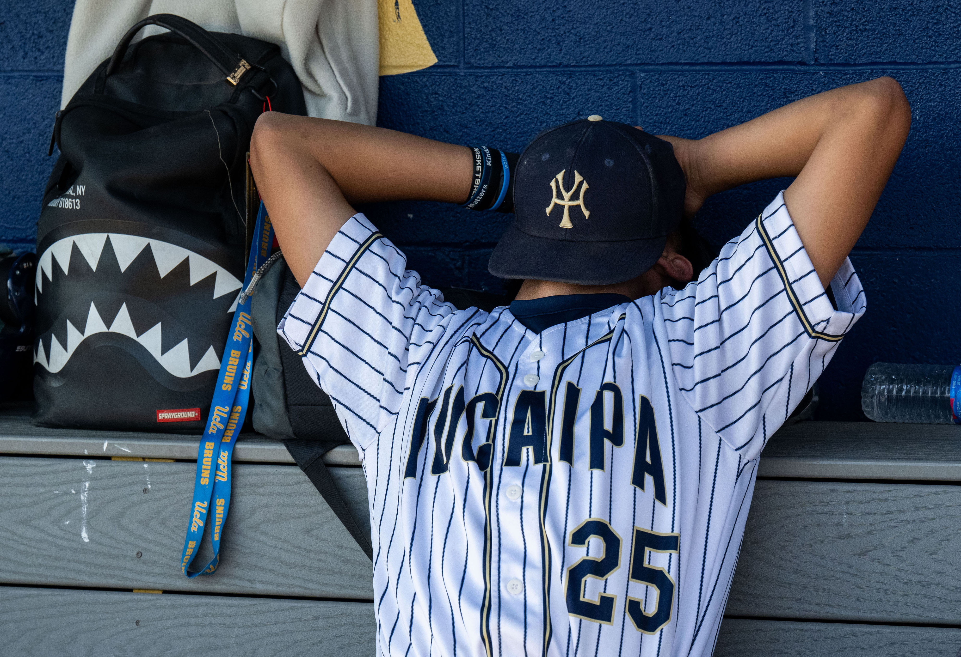 Yucaipa relief pitcher Dorian Valencia #25 reacts in the dugout...