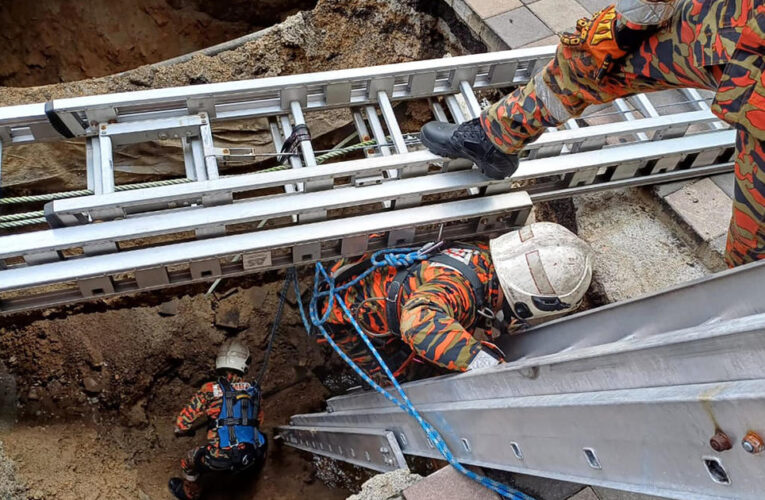 Woman buried alive in 26-foot sinkhole when pavement collapses in Malaysia