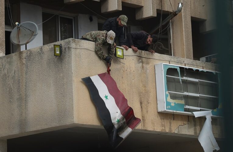 Syria latest: Syrians celebrate in the streets as Russian media says Assad has arrived in Moscow