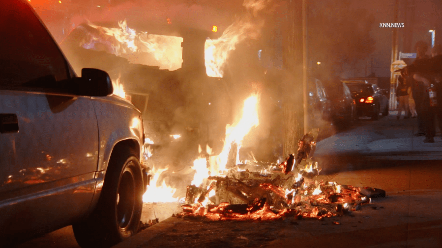 trash-burning-on-los-angeles-sidewalk-destroys-nearby-parked-car