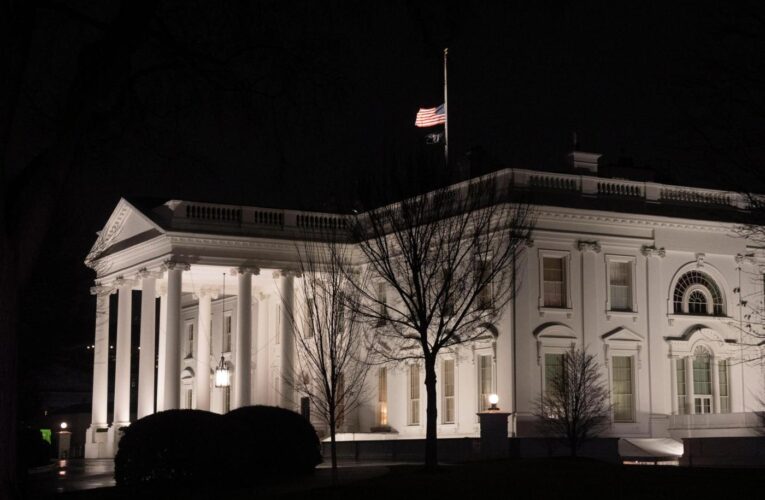 Why are US flags being flown at half-staff on Inauguration Day?