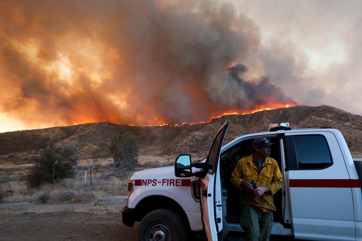 as-the-hughes-fire-swells,-some-residents-gather-near-the-flames-to-witness-the-spectacle